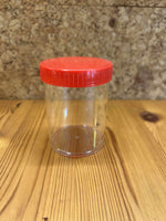 Gennemsigtig plastikbøtte med rødt låg – robust opbevaring til småting