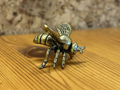 Naturinspireret bi figur i metal, ideel til boligdekoration og samling.